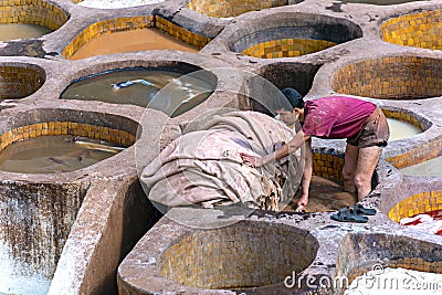 FEZ, MOROCCO â€“ APRIL 10: Local people working as a tanner in t Editorial Stock Photo